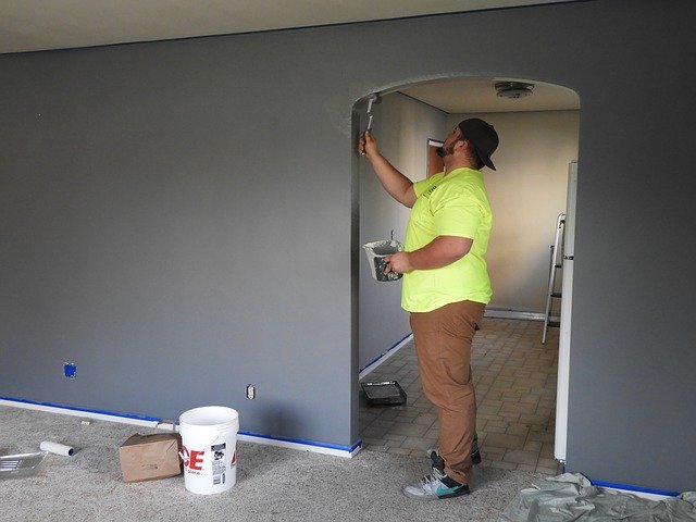a%20contractor%20touching%20up%20paint%20on%20a%20wall a%20contractor%20touching%20up%20paint%20on%20a%20wall